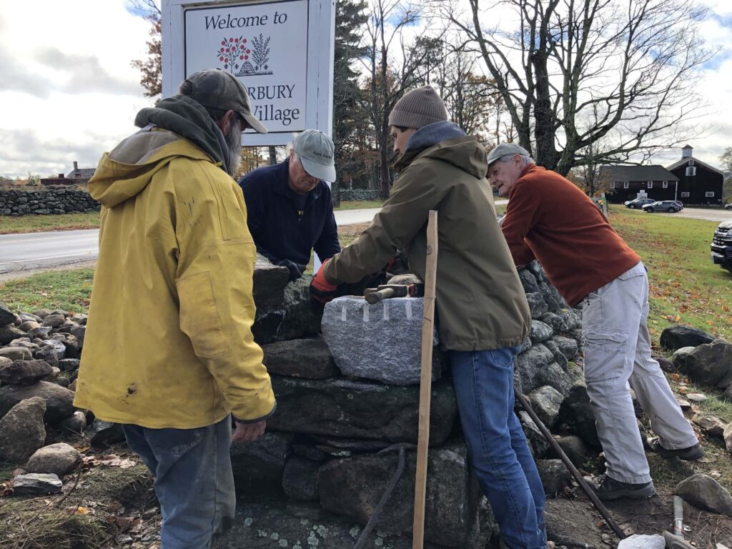 Four people participating in Stone Wall Workshop