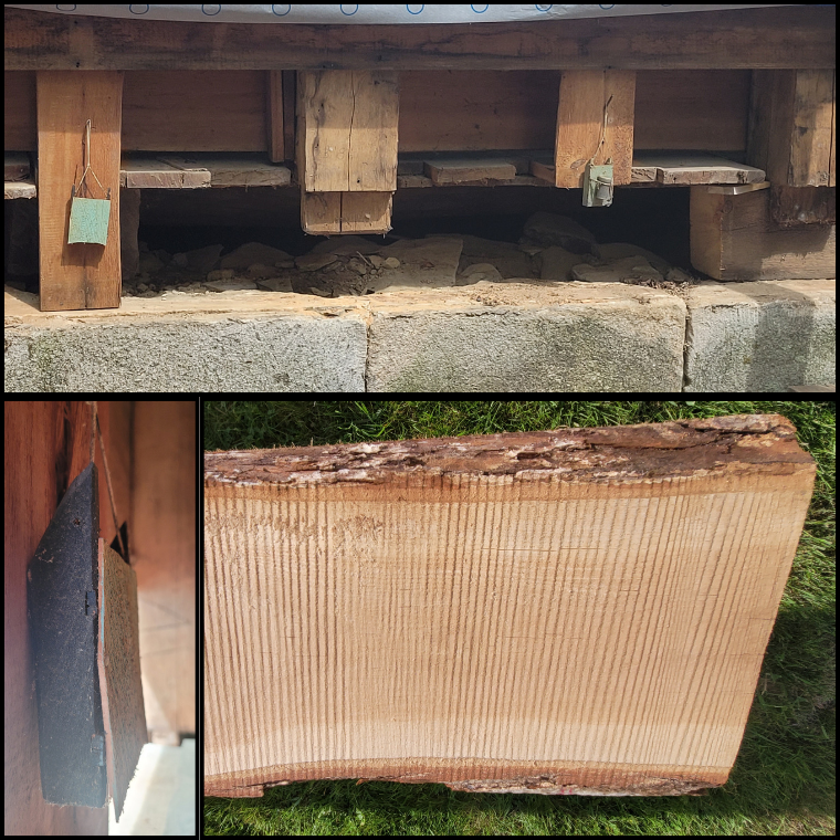 Wooden supports and weathered planks under a deck, with small metal padlocks hanging from the beams and a concrete block foundation visible beneath.